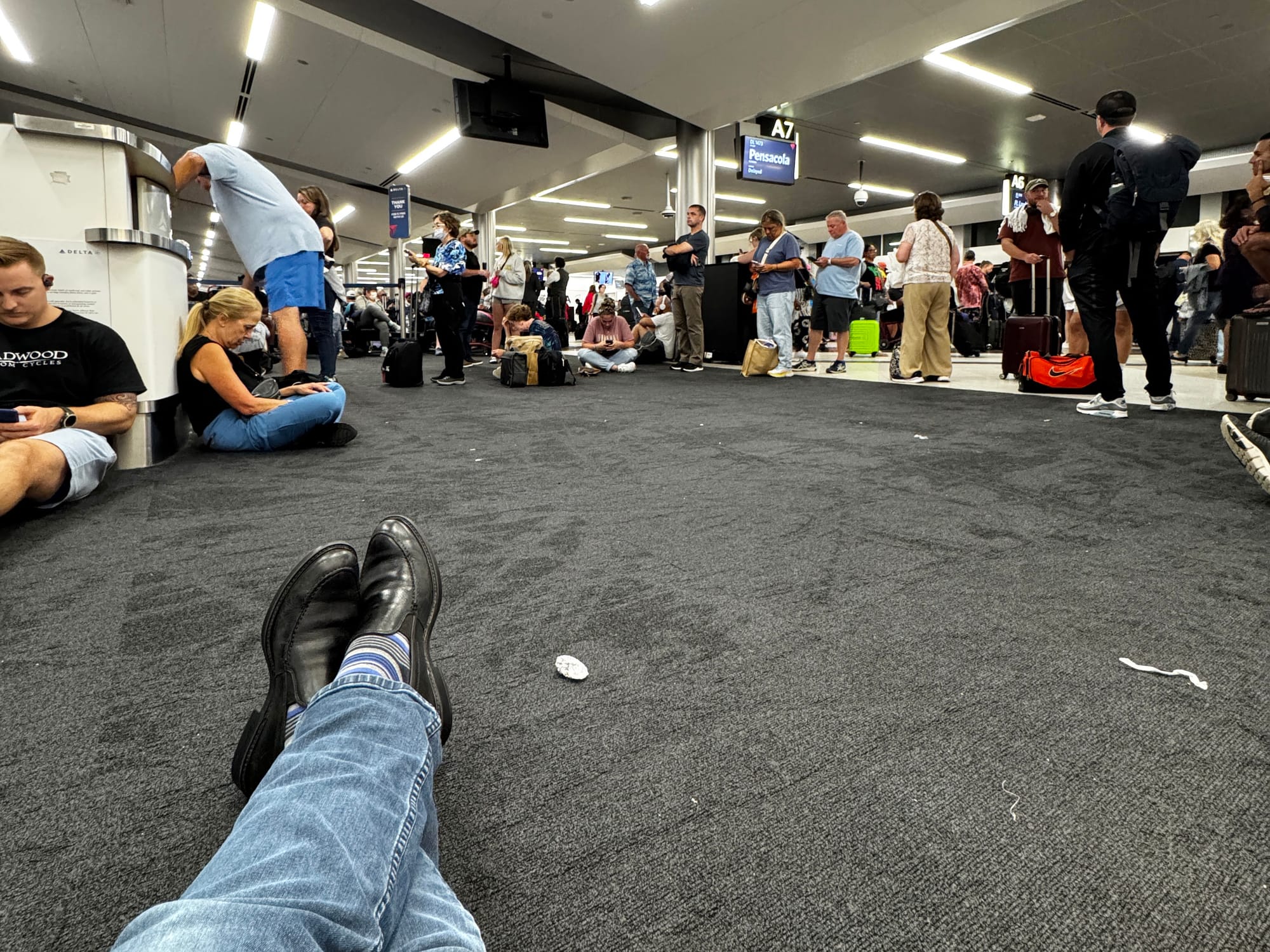 Phil Nickinson waiting on the floor of the Atlanta airport on July 21, 2024.