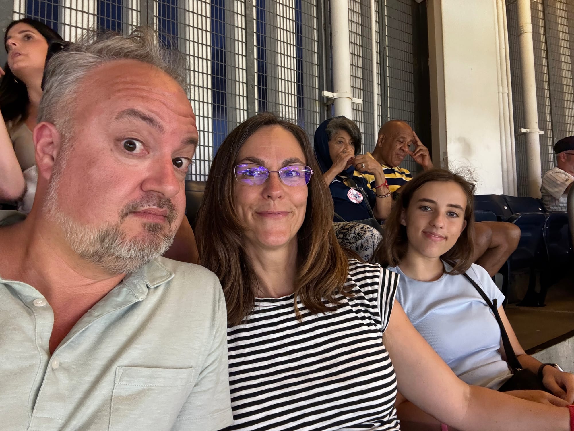 Phil, Shannon, and Isabella Nickinson sitting in Yankee Stadium in The Bronx, N.Y.