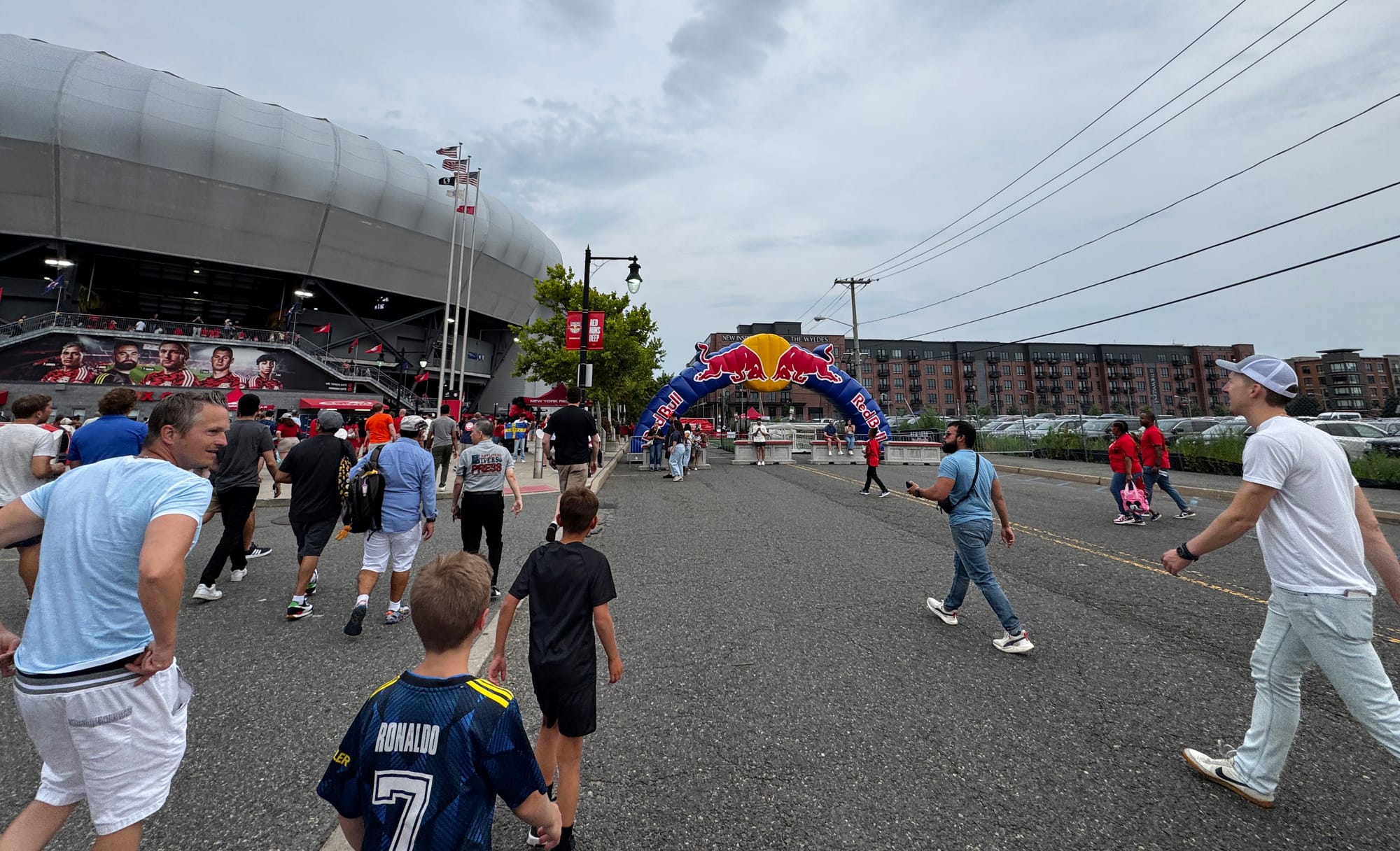 Fans walk to Red Bull Arena in Harrison, N.J., on July 20, 2024, with The Wyldes apartments next door.