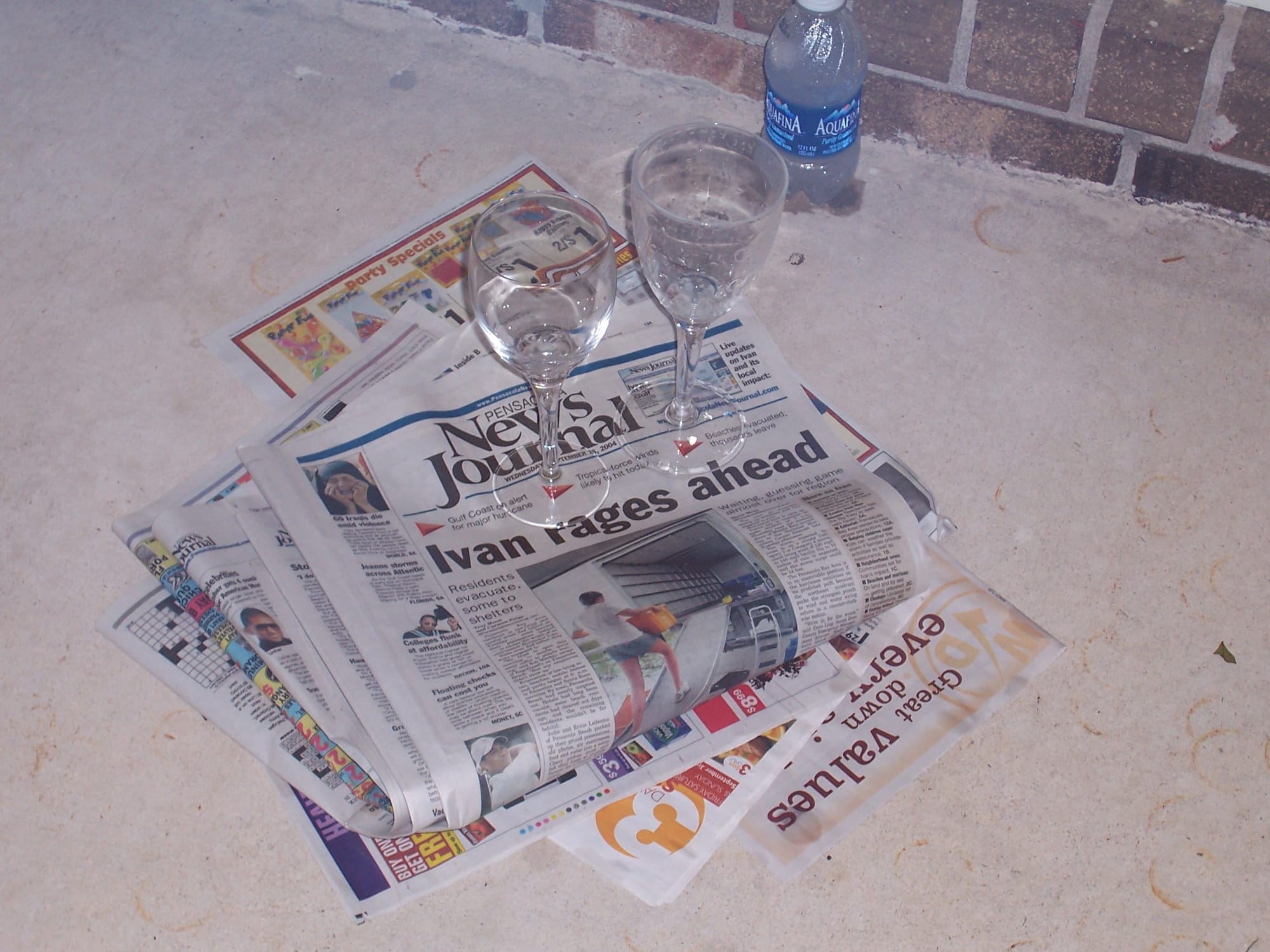 The September 15, 2004, Pensacola News Journal with a couple wine glasses on top.